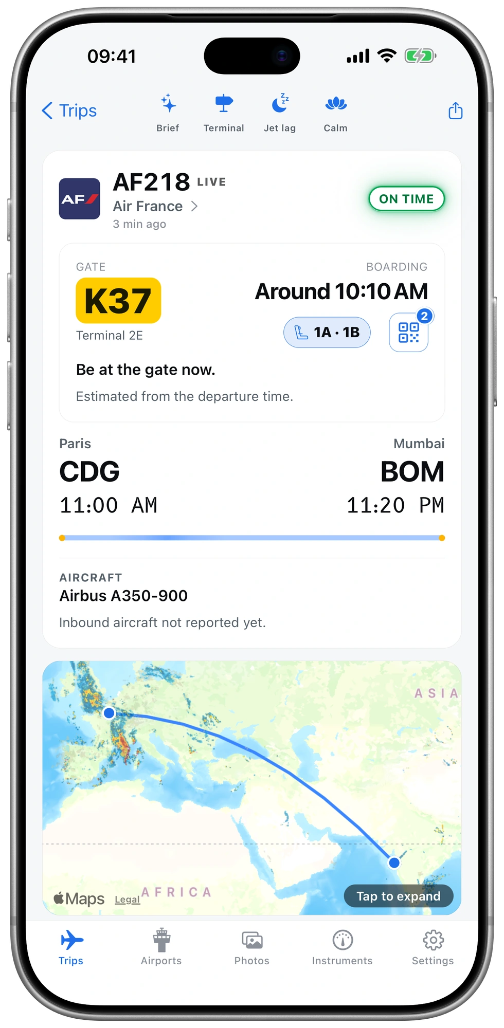 The flight screen for Air France AF218 from Paris to Mumbai before boarding: gate K37 in Terminal 2E, boarding around 10:10 AM, seats 1A and 1B, and both boarding passes one tap away.